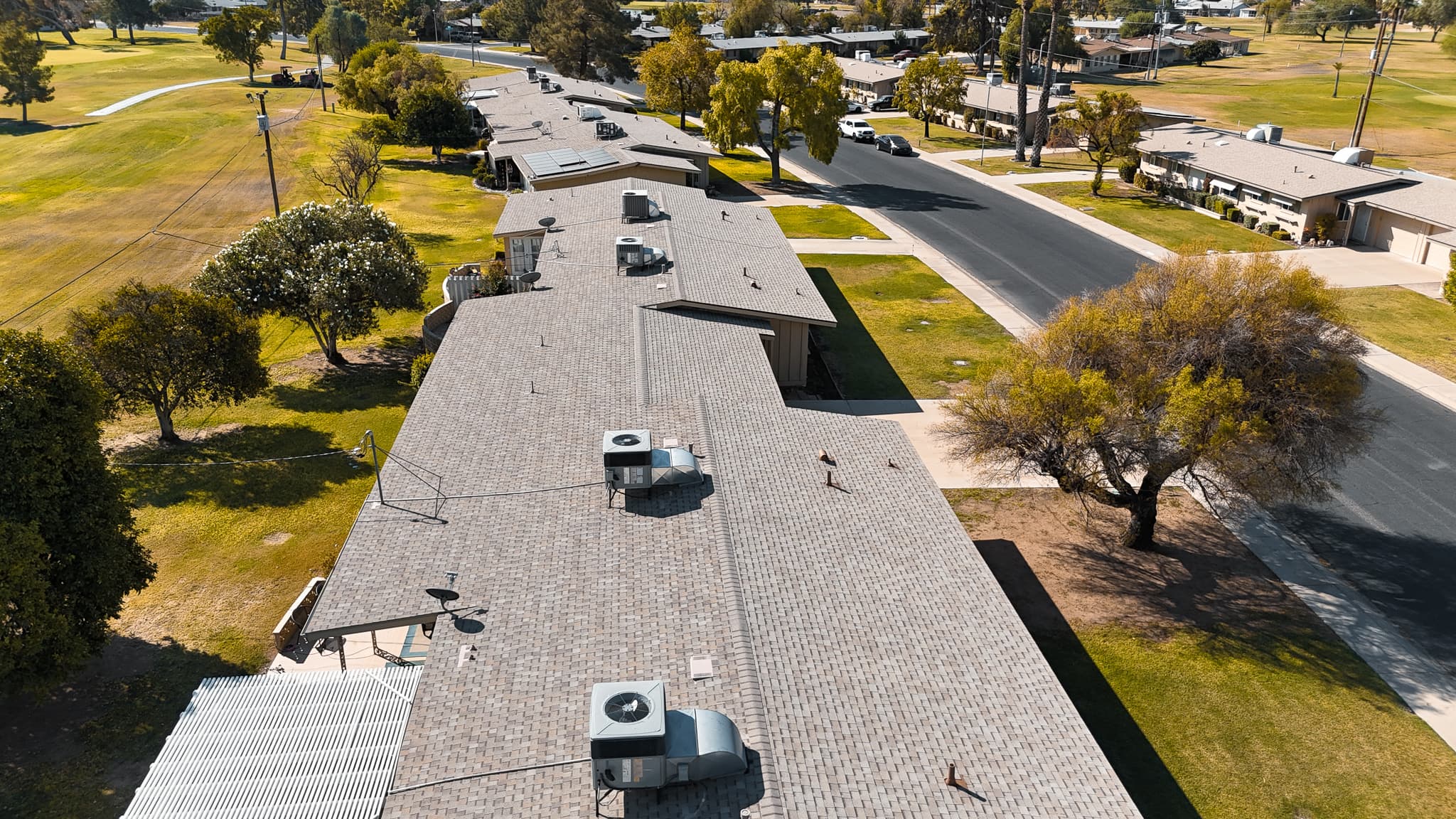Aerial drone view of a completed HailCo Roofing architectural shingle install on a Phoenix Valley property