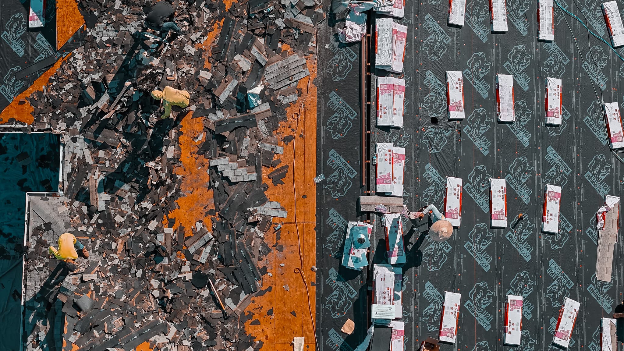 Aerial drone view of a HailCo Roofing tear-off and re-deck in progress on a Phoenix Valley home