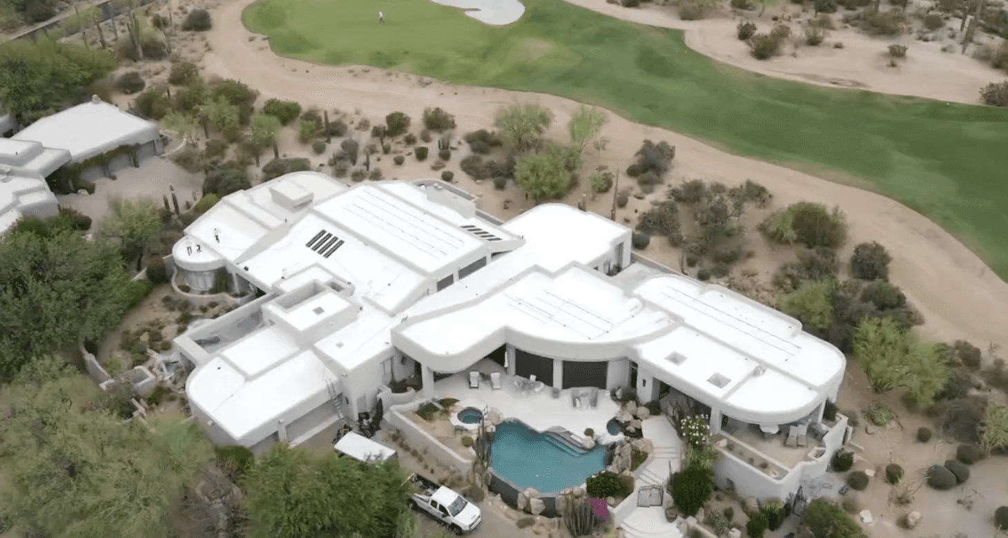 Aerial view of a Desert Highlands golf-course estate in North Scottsdale with a freshly restored white foam roof by HailCo Roofing