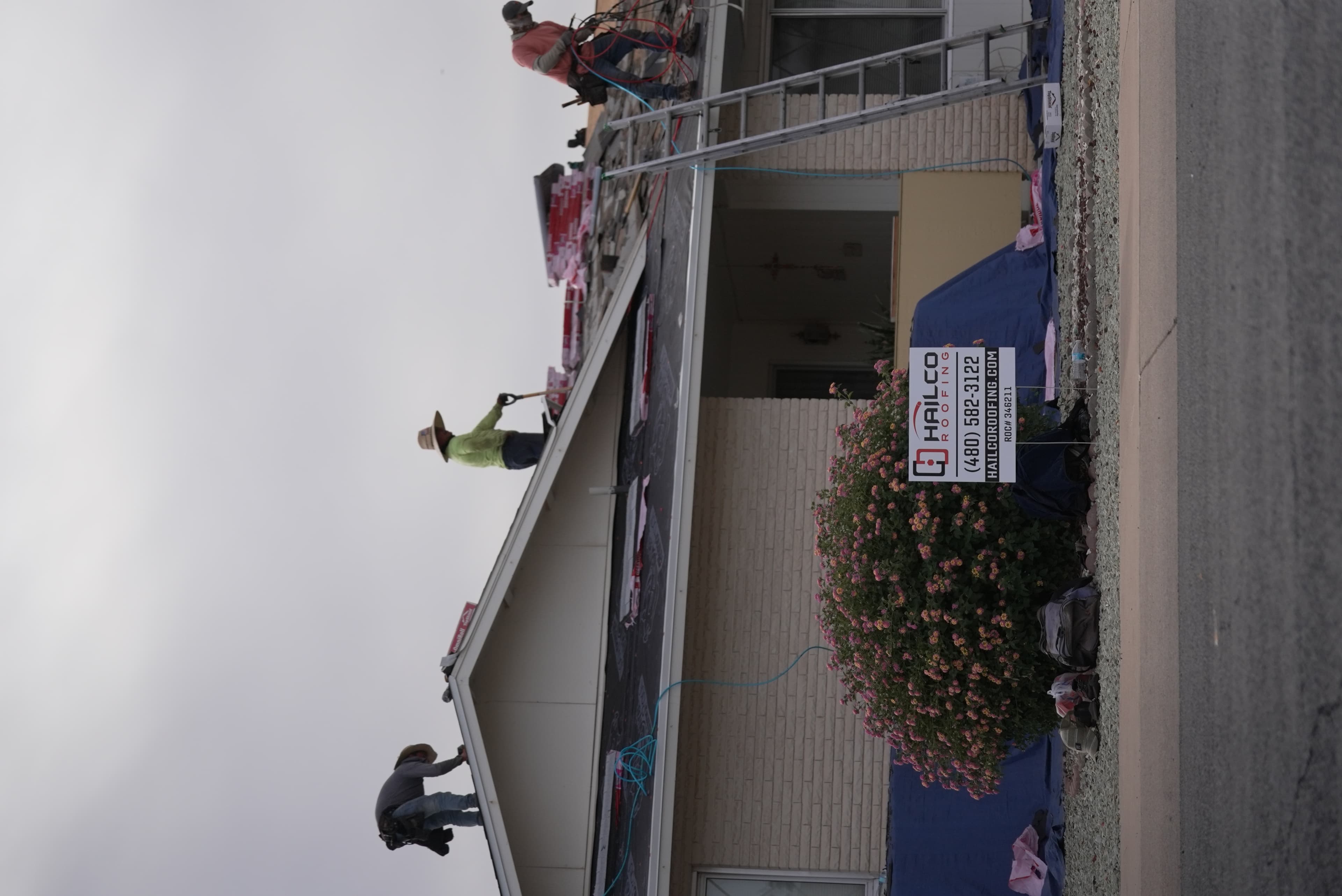 HailCo Roofing crew performing a permitted tear-off on a Scottsdale residential tile roof with City of Scottsdale building permit posted