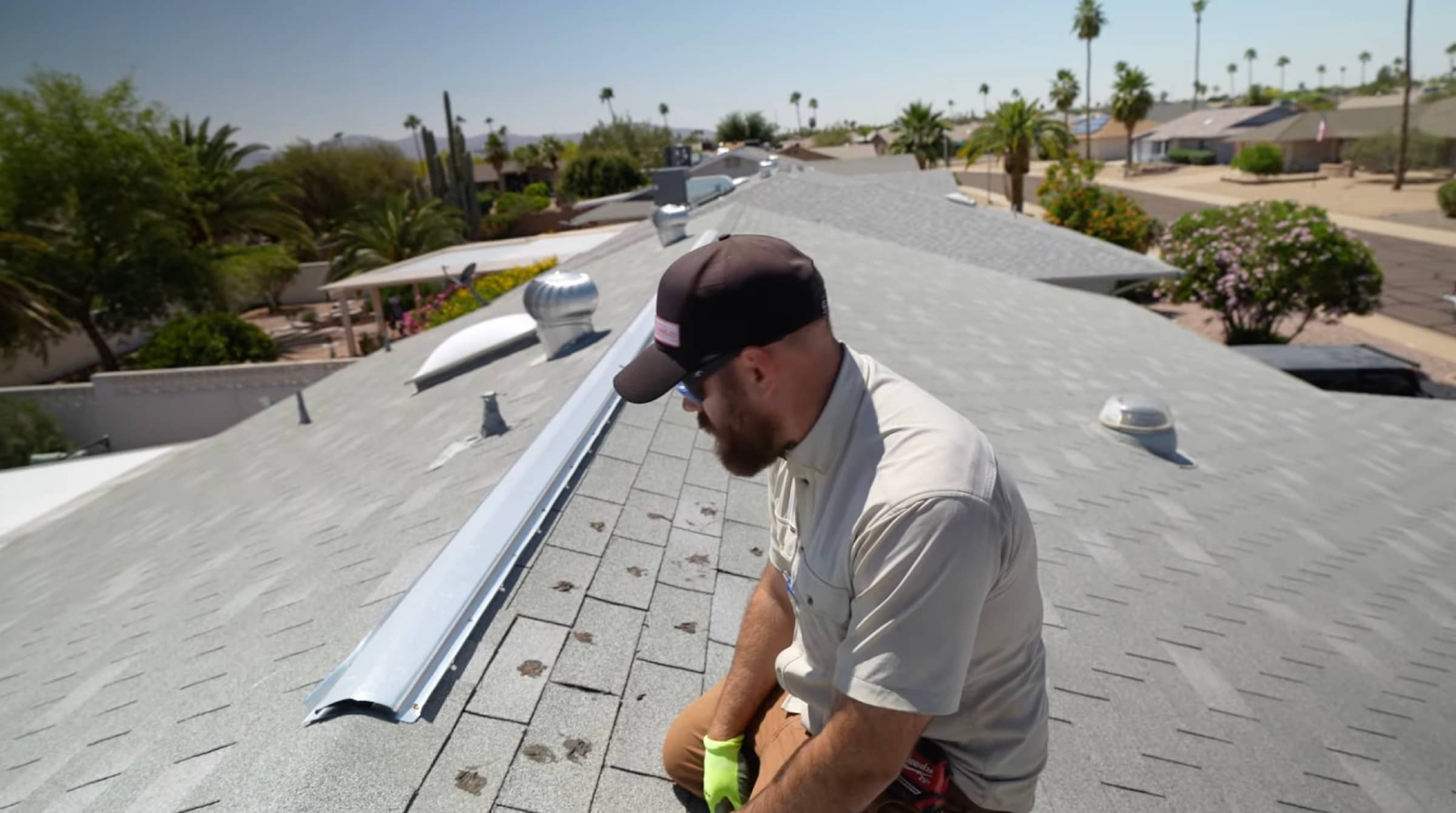 HailCo Roofing owner inspecting a flat-section foam roof on a Carefree, AZ custom desert home