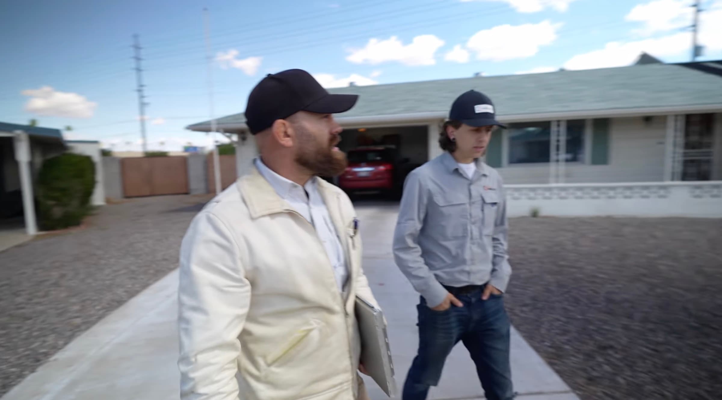 HailCo Roofing owners arriving at an Arizona home for monsoon emergency response