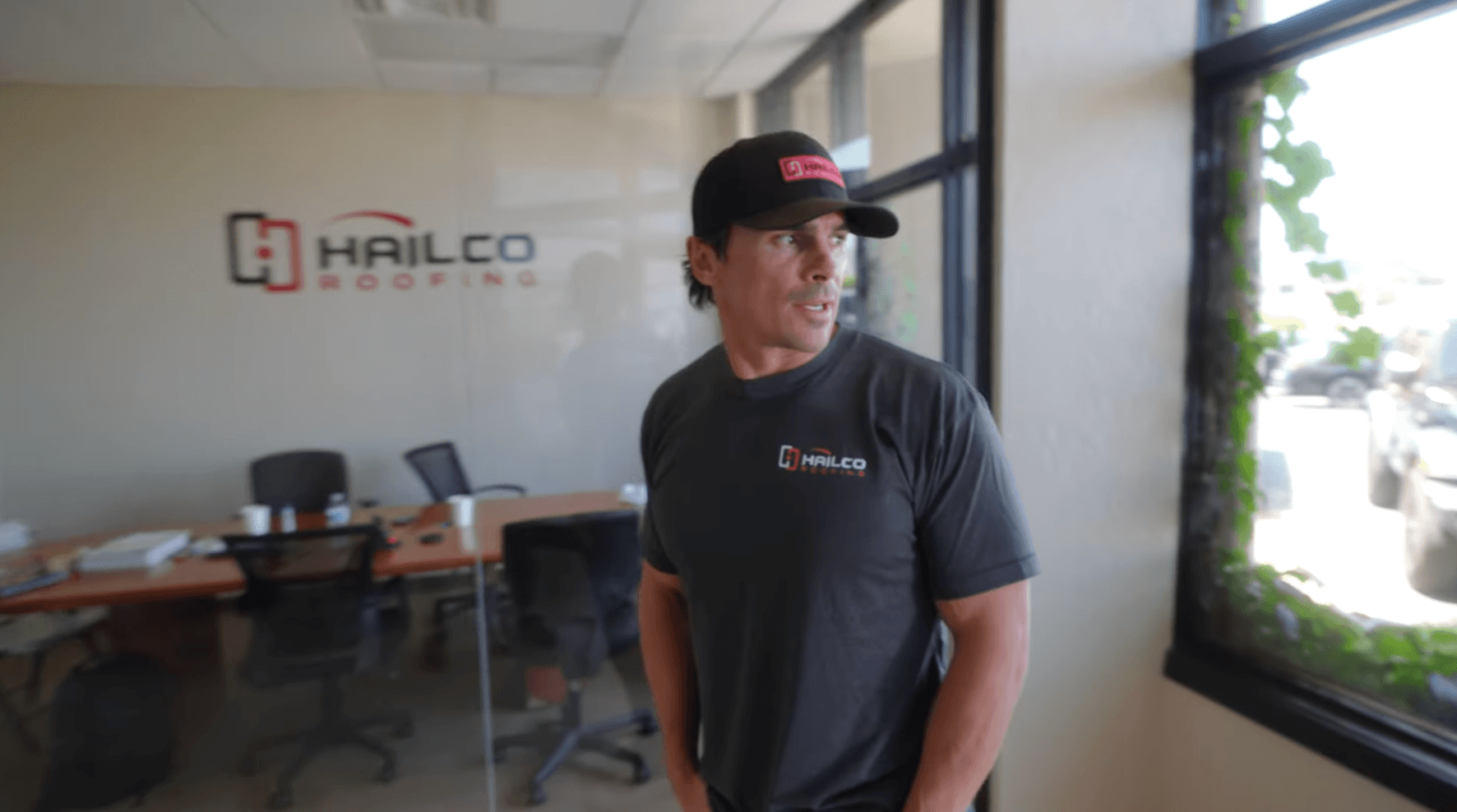 HailCo team member in the Scottsdale office with branded backdrop
